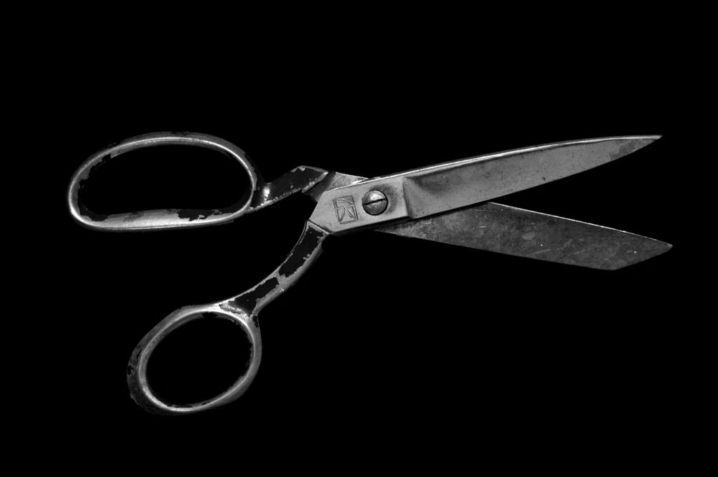 antique scissors on black background